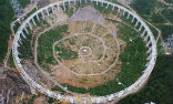 Image of China's 500-meter Aperture Spherical Radio Telescope requires the displacement of 9,110 people to prevent interference with its operations. 