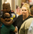 Image of A police officer embraces a friend in the aftermath of the shootings.