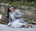 Image of A nun rests after escaping the quake. 