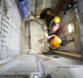 Image of Workers remove the marble covering to the ancient slab that once held the Body of Christ.