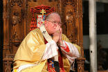 Image of Cardinal Dolan should do more to ensure donations fit the Church's needs, such as maintaining schools across the Archdiocese. The people also have an obligation to support their Church, and priests and bishops deserve breaks. Dialogue all around may improve the situation for the Archdiocese.
