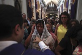 Image of A penitent Christian coming forward to receive ashes at an Ash Wednesday liturgy
