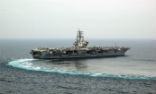 Image of The aircraft Carrier Ronald Reagan (CVN76) performs a turn at sea. The U.S.S. Carl Vinson (CVN 70) is keeping the peace in the Western Pacific at this time.