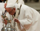 Image of Pope Francis inspects a jar of holy oil during the Chrism Mass.