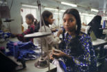 Image of A girl works in a sweatshop, sewing garments. Large numbers of people are enslaved or at least unethically employed. Many products produced by such labor are cheap in price for the consumer, but expensive for the worker. 