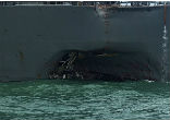 Image of The USS John S. McCain suffers significant damage after a collision with a Liberian-flagged oil tanker.