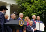 Image of Priests for Life's Alveda King, second from left, watches as President Trump signs an executive order on religious liberty in May 2017.