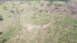 Image of The site of an abandoned village, centuries old, surrounded by earthworks. 