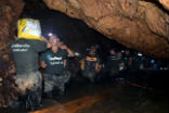 Image of Rescuers work to drain water and make the cave more accessible in an effort to rescue the soccer team. 